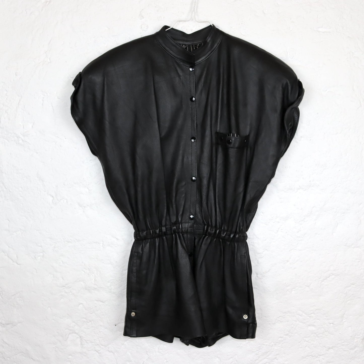 Vintage 80s 90s jumpsuit one-piece short sleeve shoulder pads leather black short button placket fitted 36